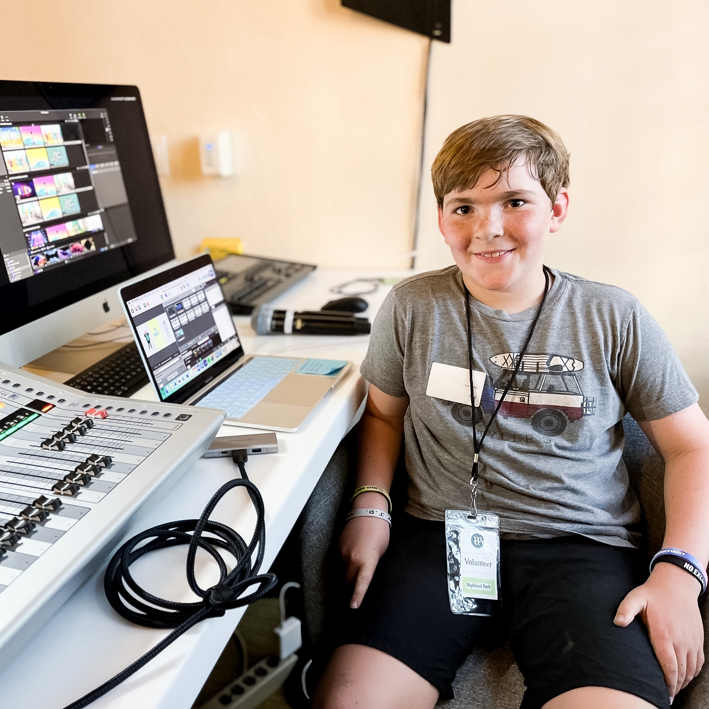 Young boy sitting in front of a tech booth