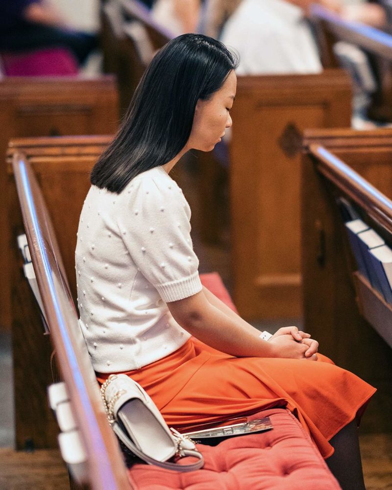 woman praying in sanctuary