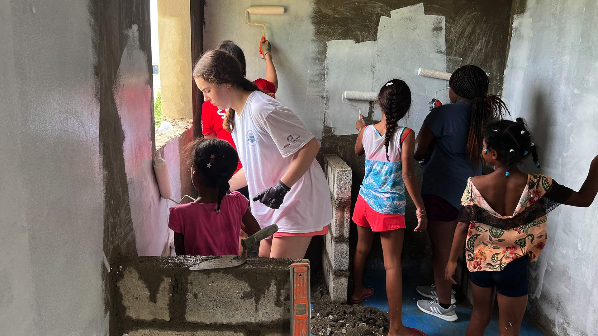 students and children painting house